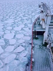 Ice Breaker ship and sea ice in the frozen Antarctic ocean
