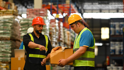 Displeased male manager scolding young frustrated intern about bad work results, damaged cardboard box. Stress at work concept
