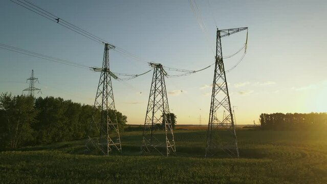 High voltage power lines at sunset. Aerial view