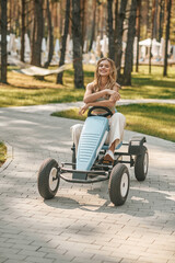 Young woman riding quadrocycle and looking excited