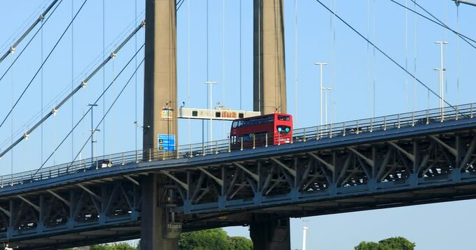 Red Double Decker Bus Crossing the Tamar Bridge Between Devon and Cornwall.