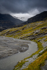 Lämmerenboden with meandering creek and wildstrubel glacier in the distance in valais