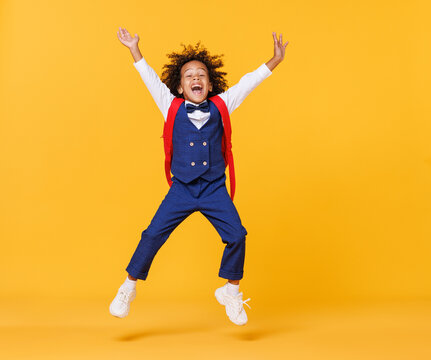 Energetic Ethnic Stylish Schoolboy Leaping Up