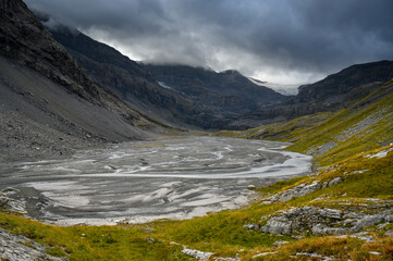 Fototapeta na wymiar Lämmerenboden with meandering creek and wildstrubel glacier in the distance in valais