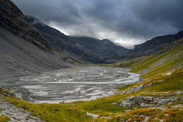 Naklejka na ściany i meble Lämmerenboden with meandering creek and wildstrubel glacier in the distance in valais