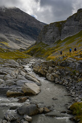 Fototapeta na wymiar alpine hikers near mountain creek on Gemmi Pass in Valais