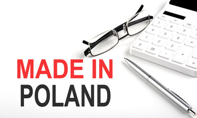 MADE IN POLAND Concept. Calculator,pen and glasses on the white background