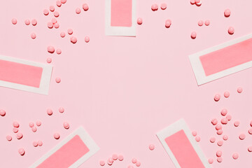 Pink depilatory wax strips, depilatory wax granules on a pink background. Place for text. Epilation, depilation, removal of unwanted hair. Top view.