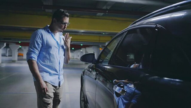 male driver in the parking lot static electricity shock from the car door portrait