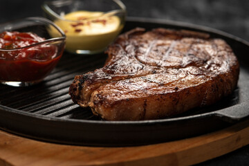 pork steak with vegetables in a black iron pan