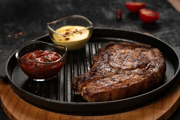 pork steak with vegetables in a black iron pan