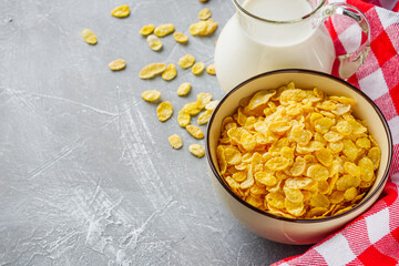 crispy golden cornflakes on a gray concrete background