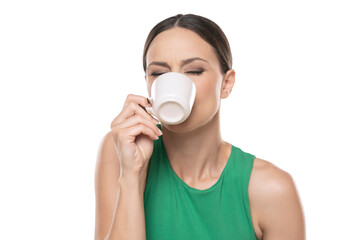 Joyful young woman with cup of hot beverage on a white background.