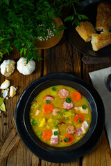 Hearty rustic pea soup with bacon and sausage