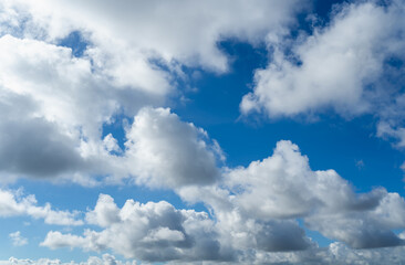Obraz premium Clear blue sky and white clouds. Air clouds in the blue sky. Beautiful white cloud on clear blue sky as nature concept. Abstract style for text, design, pattern, background