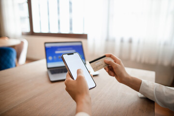 woman hands using smartphone and laptop computer for online shopping at home, Hand holding mobile phone with Payment Detail page display and credit card, online shopping concepts.