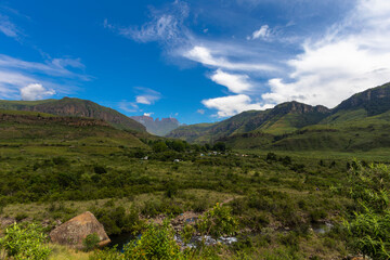 Green foothills in front of the mountain