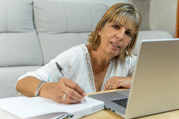 Adult woman writing in her diary looking at the camera