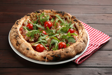 Tasty pizza with meat and arugula on wooden table
