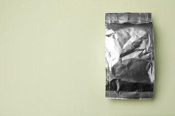 Blank foil package on light background, top view. Space for text