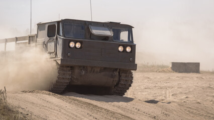 Fototapeta premium TRACKED ARTILLERY TRACTOR - Military vehicle on a dirt road