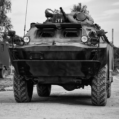 Fototapeta premium COMBAT RECONNAISSANCE-PATROL VEHICLE - A camouflage scout on a country road 
