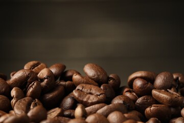Heap of aromatic roasted coffee beans, closeup