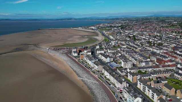 4K: Aerial Drone Video of Morecambe Bay in Lancashire, UK. Approach shot with Beach & Road. Stock Video Clip Footage. Wide 