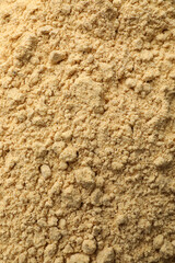 Aromatic mustard powder as background, top view