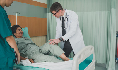 Male doctor wearing a uniform, asking questions about the duty, knee of the patient, clinic, consulting, diagnosis, examining doctor