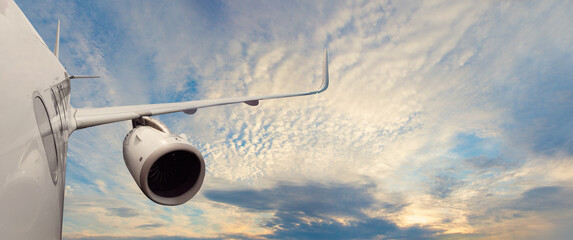 Flying, traveling and transportation concept. View from airplane and sky clouds on sunset time