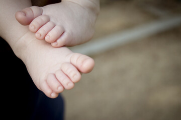 Two month old baby feet on black background