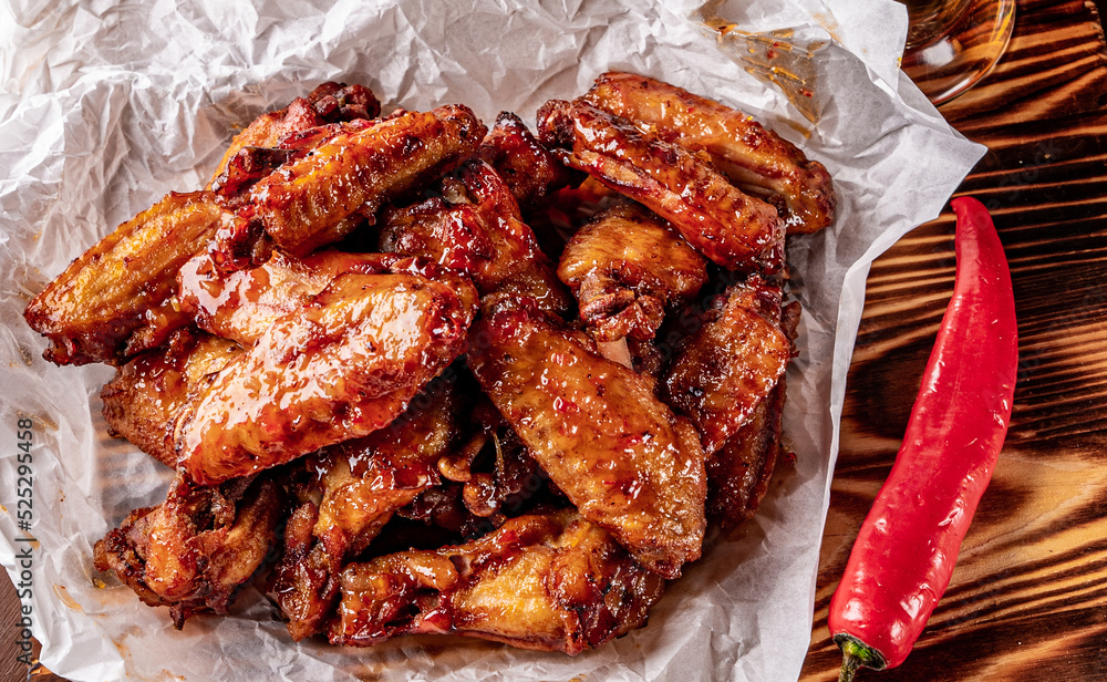 Wall mural fried chicken wings with sweet chili sauce on white paper