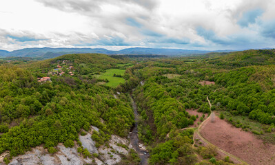Fototapeta premium Panorama of a valley with waterfall, top view. Travel in Bulgaria. Hristovski waterfall