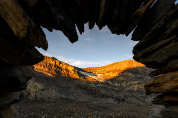 stone arch near Lämmerenhütte with the remains of Lämmerengletscher in Valais at sunrise - obrazy, fototapety, plakaty