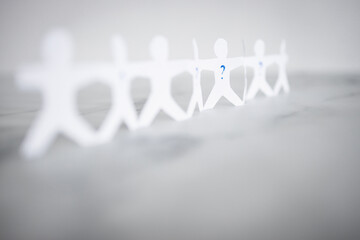 staff shortages and hiring personnel, paper people chain with question marks on some people symbol...