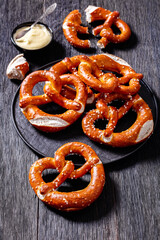 pretzels in the form of knot with cheese sauce