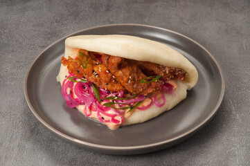 bao bun with breaded chicken, pickled onion and sauce