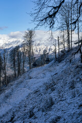 Peaks of a mountain range with cumulus clouds in Krasnaya Polyana