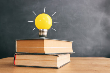 Education concept image. Creative idea and innovation. light bulb metaphor over blackboard...