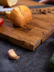 Wooden cutting board, linen textile and cutlery. Food background with copy space. Table top view