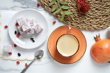 cup of fresh coffee and a cube of soft Turkish delight, Turkish tea drinking, top view.