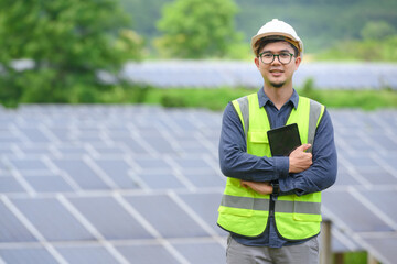 Asian male engineer Work with solar panels and install solar panels at photovoltaic power stations...