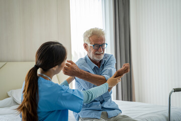 Doctor or nurse caregiver exercise with senior man,Medical Consultant,Nurses rehab exercises and take care senior disabled man.
