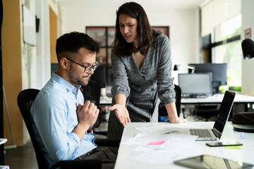 Colleagues arguing in office. Angry businesswoman yelling at her collegue