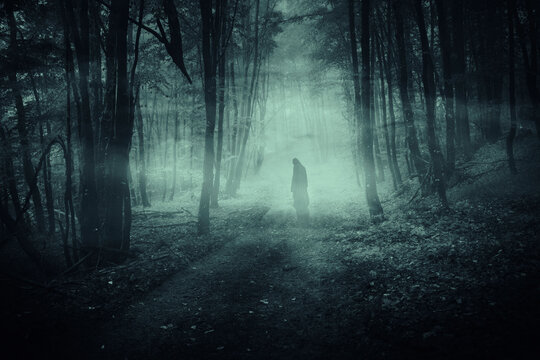 scary ghost in dark mysterious forest