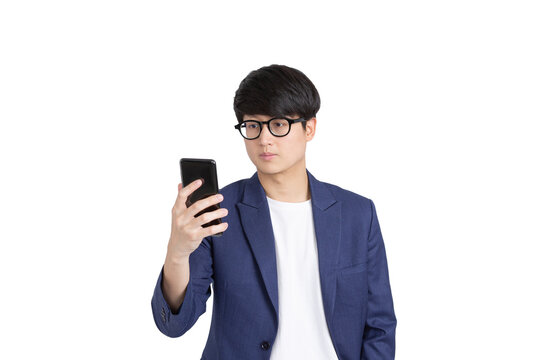 Image of handsome asian young adult man in glasses holding and looking at cellphone on transparent as png