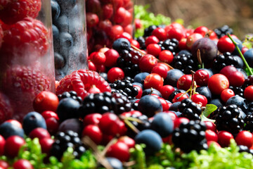 Berries fresh assorted mix overhead arrangement close up in studio on dark background.