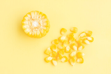 Yellow corn cobs slice with seeds on yellow background