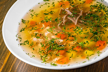 Bowl of meat and vegetable soup on a table